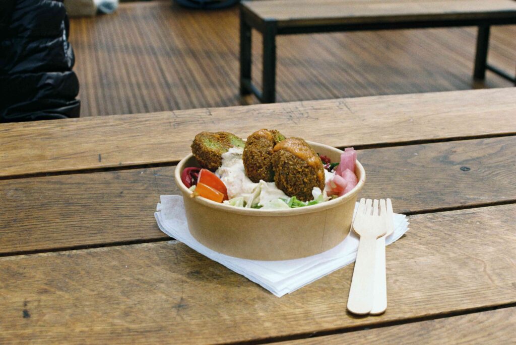 best falafel in riyadh in a plastic bowl on a table